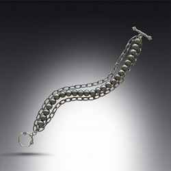 Double Stainless Steel Chain silver bracelet with round steel beads. It clasps with a silver pewter lobster clasp.